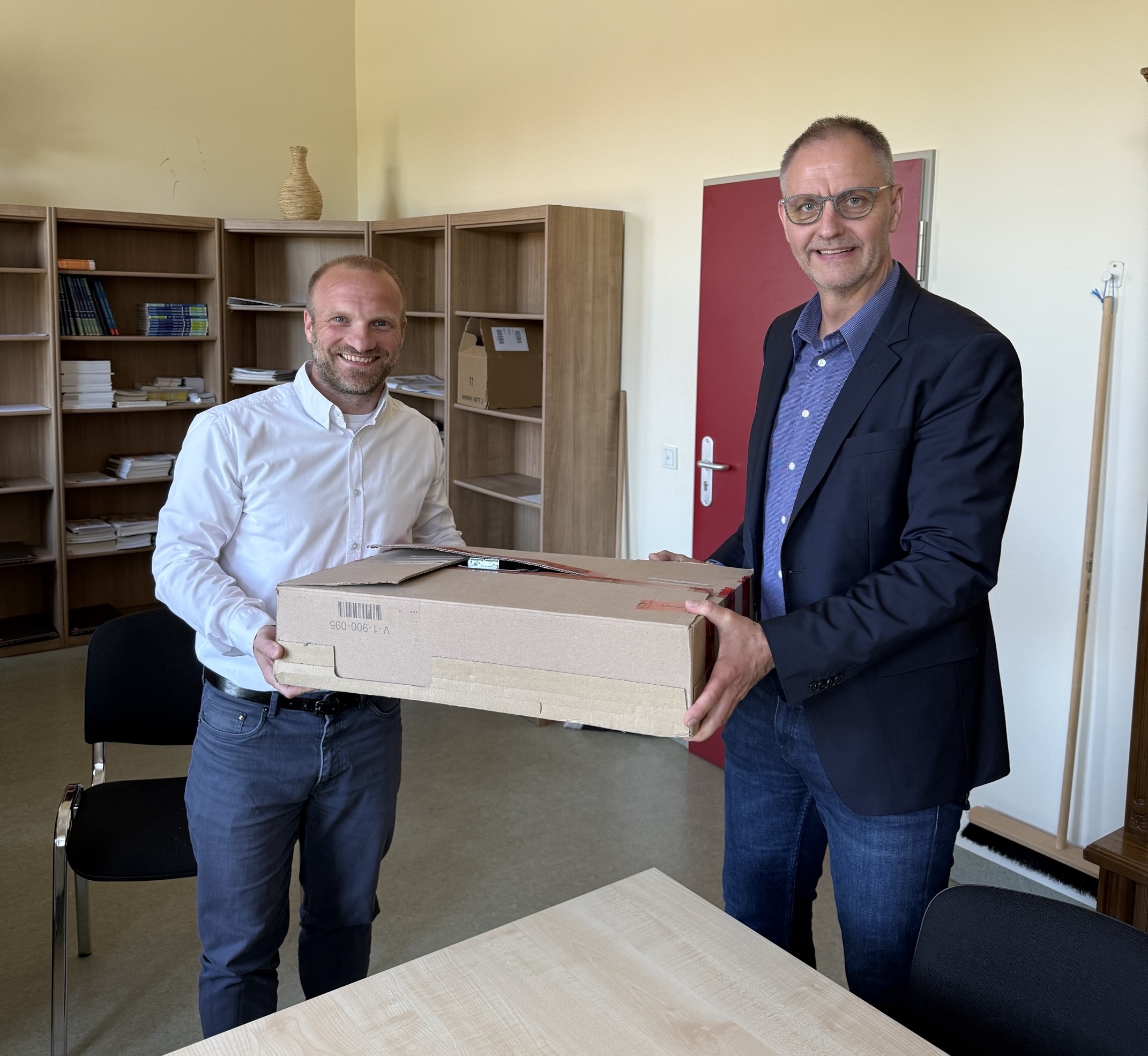 Wolfgang Roick überreicht der Oberschule Großräschen eine digitale Zeitmessanlage.